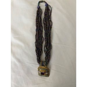 Multi-strand necklace purple, blue with medallion, used